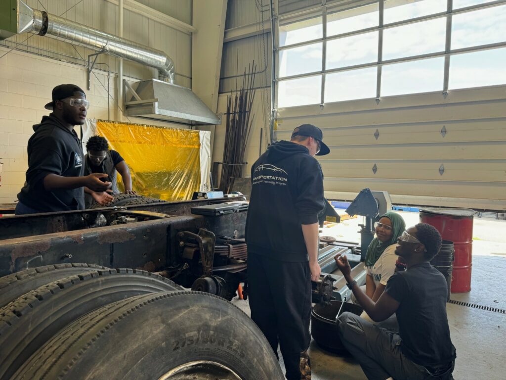 students working on a truck